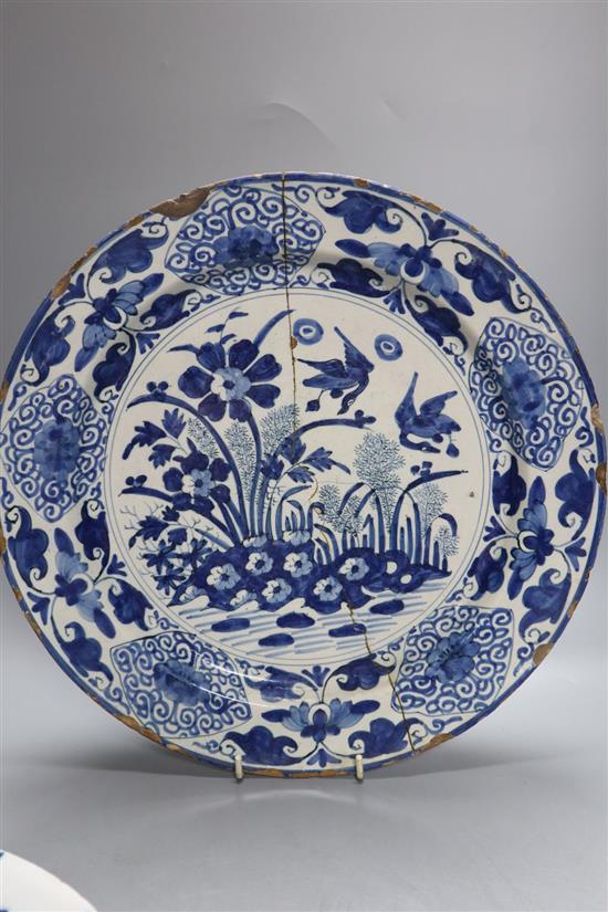 Two 18th century Delft blue and white dishes and a similar English delftware dish, 34-35cm, all a.f.